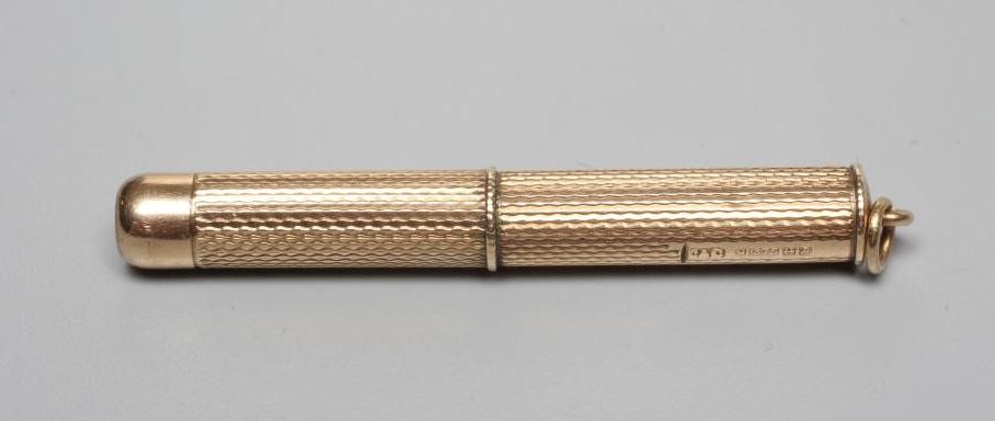 A 9CT GOLD PROPELLING TOOTHPICK, maker's mark rubbed, Birmingham 1964, with engine turning and Image