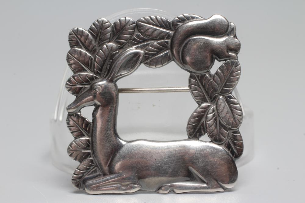 A GEORG JENSEN SILVER SQUARE BROOCH designed by Arno Malinowski with a recumbant deer and squirrel, Image
