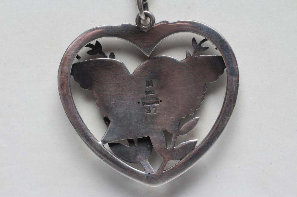 A GEORG JENSEN SILVER DOVE IN HEART PENDANT designed by Arno Malinowski, stamped Sterling 97, on an Image