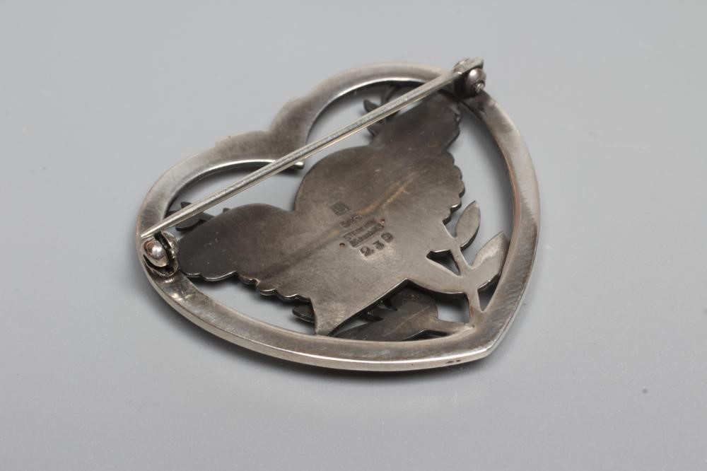 A GEORG JENSEN SILVER DOVE IN HEART BROOCH designed by Arno Malinowski, stamped GJ Sterling 239 Image