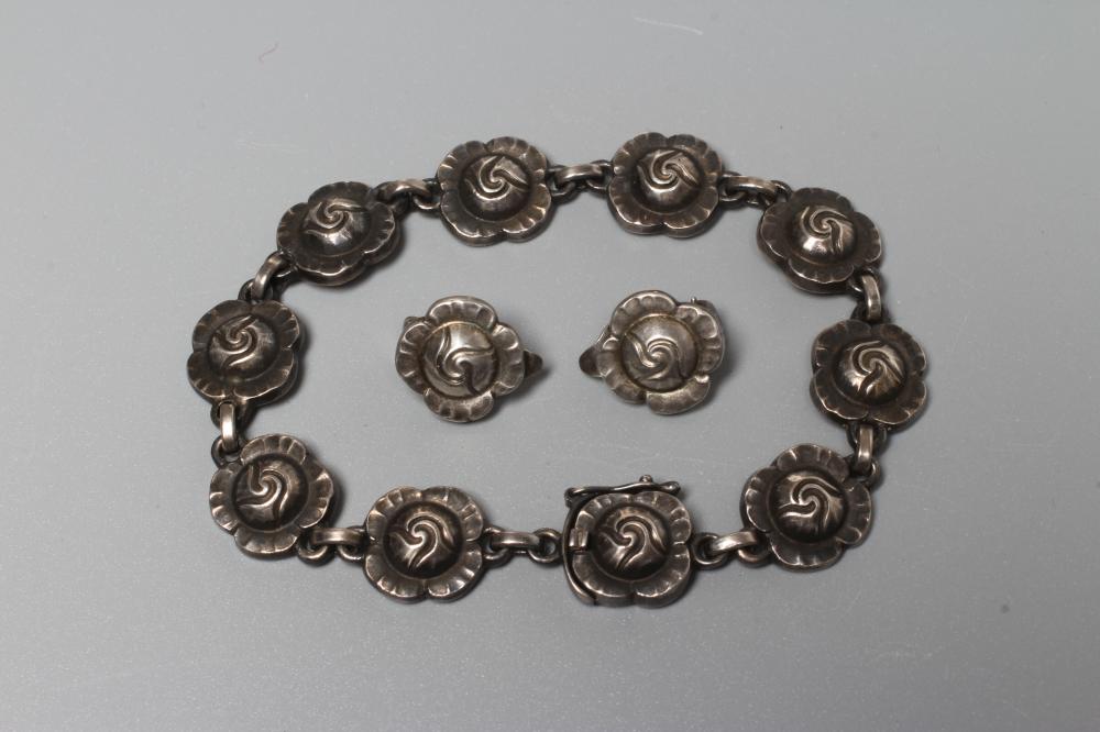 A GEORG JENSEN SILVER ROSE BRACELET designed by Georg Jensen, stamped Sterling 44, together with a Image