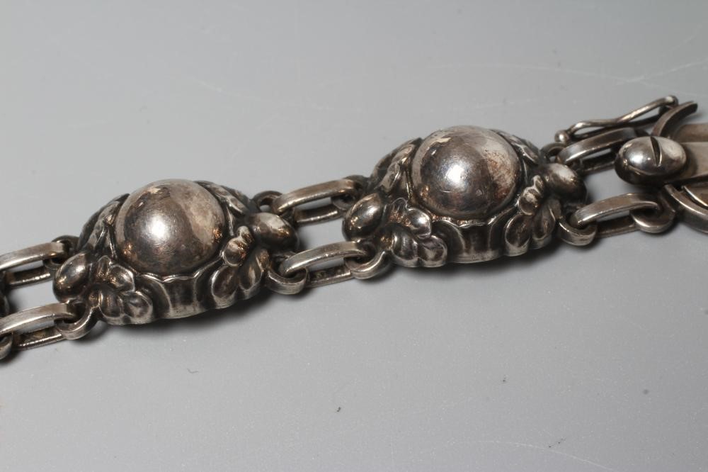 A GEORG JENSEN SILVER BRACELET designed by Georg Jensen as six stylised flowerhead bosses with slide Image
