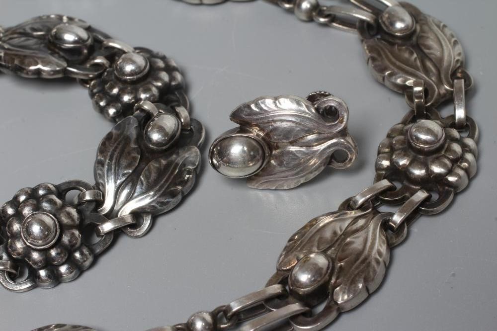 A GEORG JENSEN SILVER SUITE designed by Georg Jensen with stylised flowerhead bosses and comprising Image