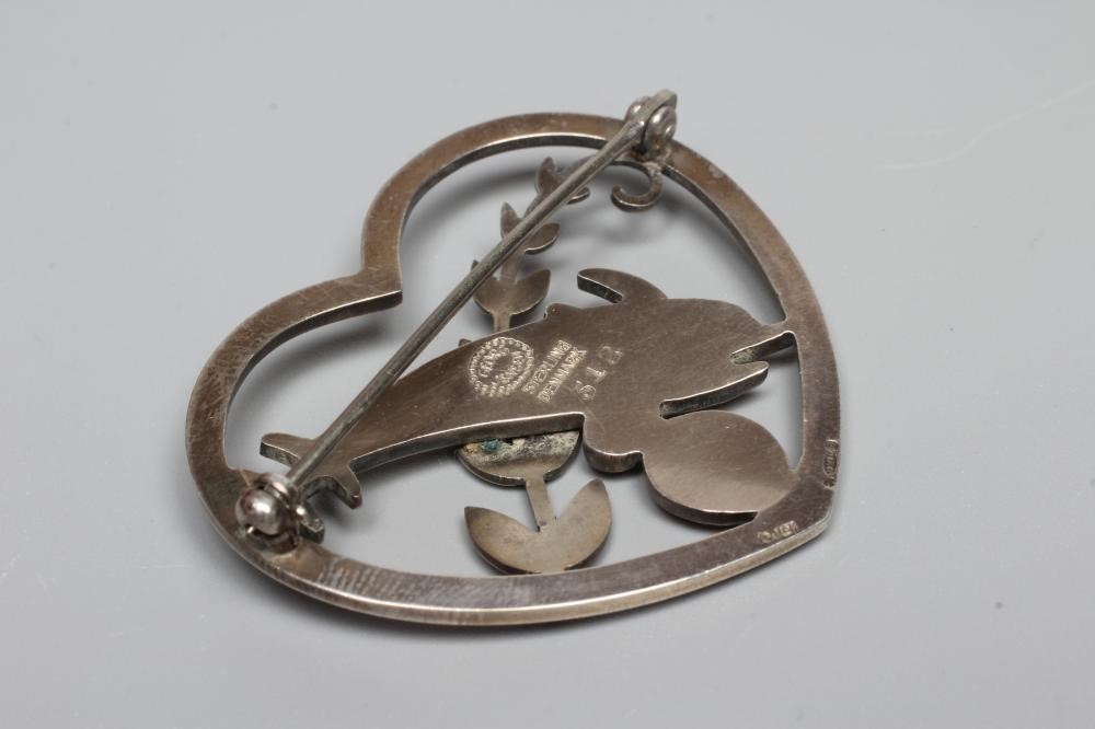 A GEORG JENSEN SILVER HEART BROOCH designed by Arno Malinowski with two dolphins swimming amidst Image