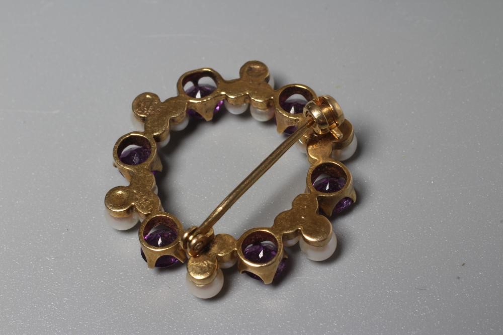 AN AMETHYST AND CULTURED PEARL WREATH BROOCH claw set with six facet cut amethysts and six triple Image