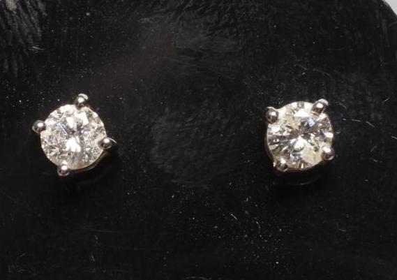 A PAIR OF DIAMOND SOLITAIRE EAR STUDS Image