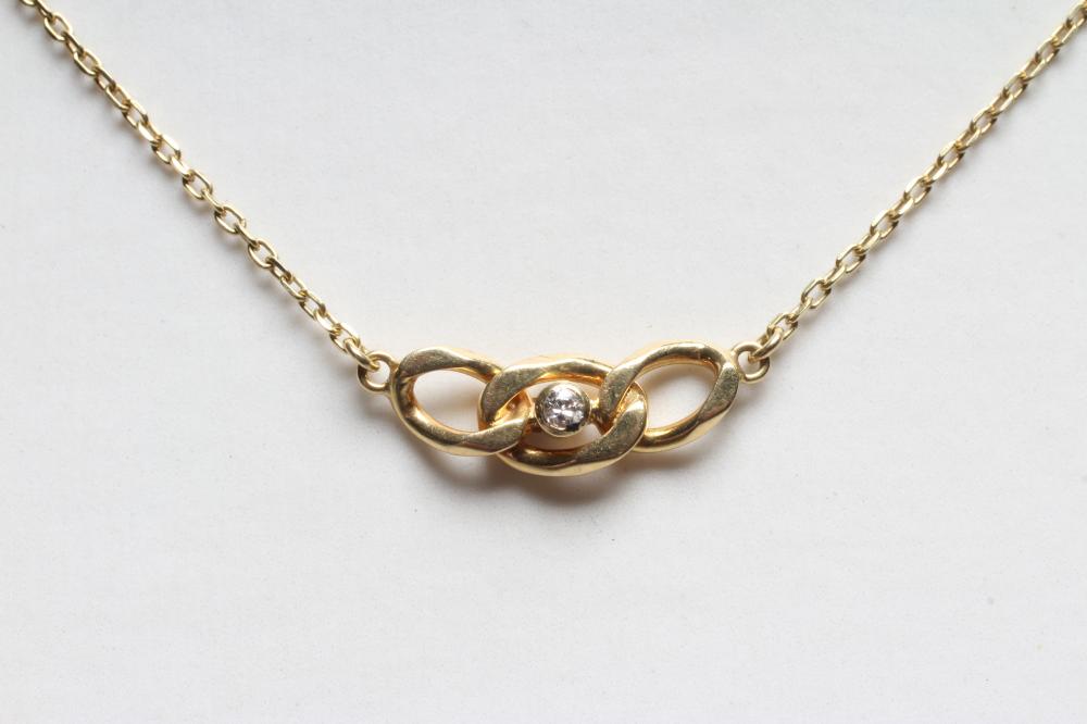 AN 18CT GOLD NECKLACE, the triple chain link 'pendant' centred by a small brilliant cut diamond Image