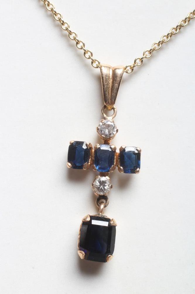 A SAPPHIRE AND DIAMOND CROSS PENDANT Image