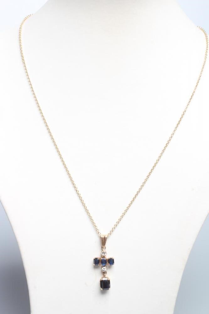 A SAPPHIRE AND DIAMOND CROSS PENDANT Image