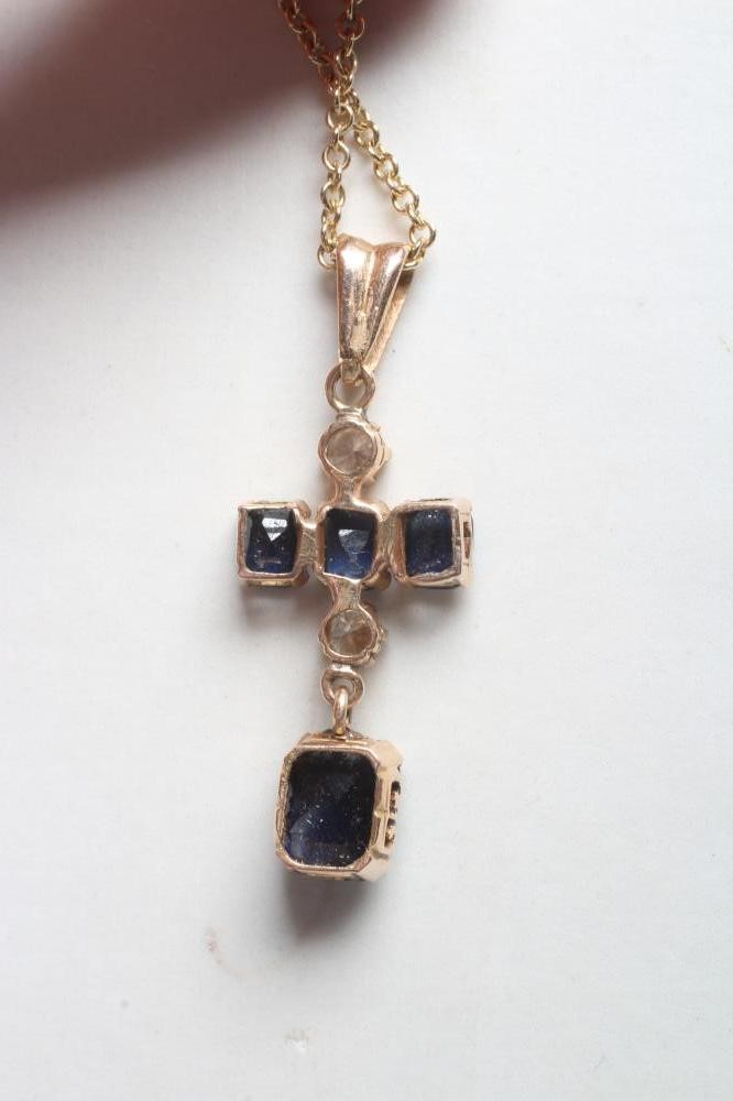 A SAPPHIRE AND DIAMOND CROSS PENDANT Image