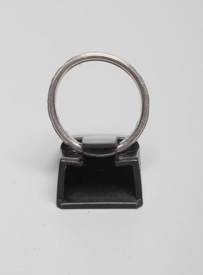 A PLATINUM ETERNITY RING with small diamonds in rub-over settings, London, 5.1g gross, size J 1/2 Image