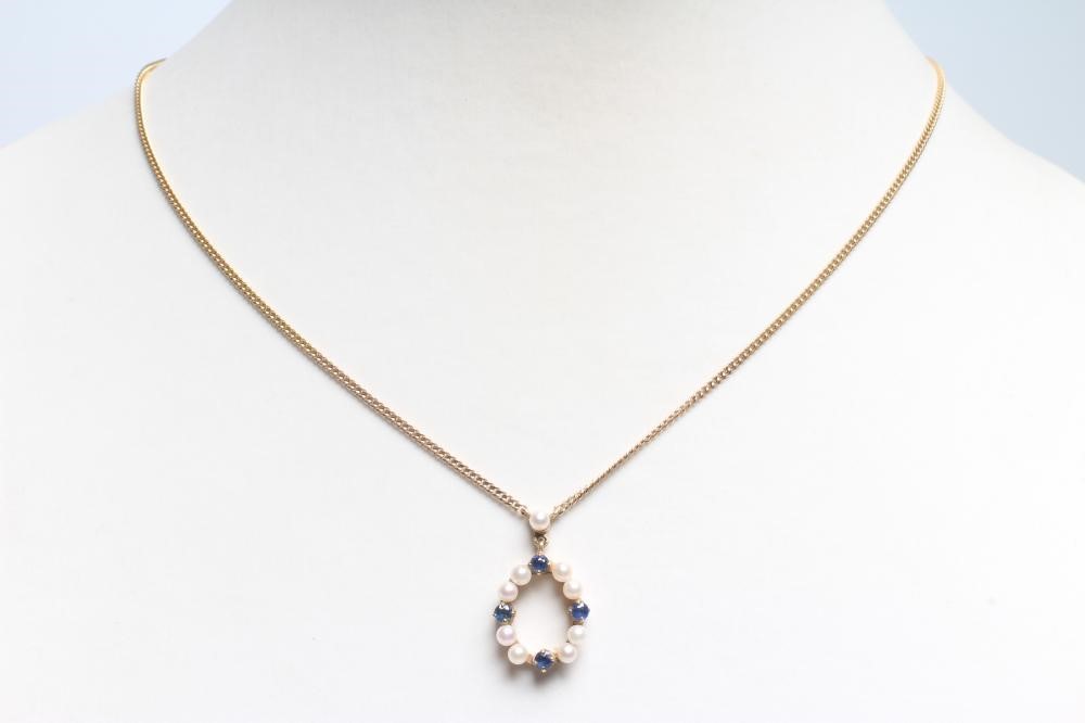 A CULTURED PEARL AND SAPPHIRE OVAL PENDANT peg set with four pairs of small pearls interspersed with Image