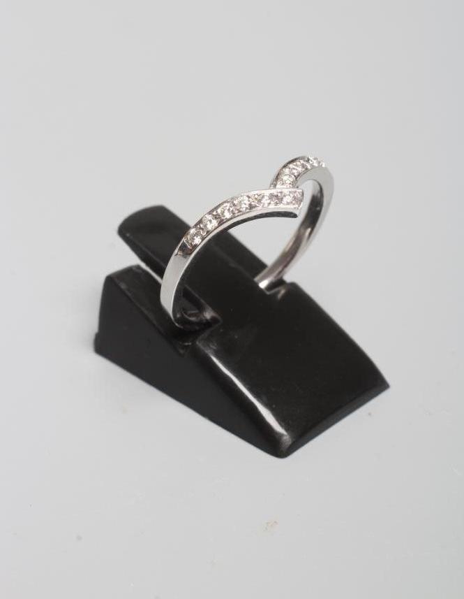 A DIAMOND WISHBONE ETERNITY RING, the eleven small stones pave set to a plain 18ct white gold shank, Image