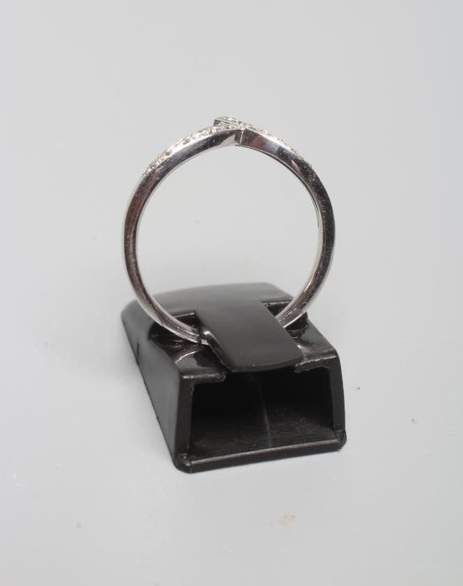 A DIAMOND WISHBONE ETERNITY RING, the eleven small stones pave set to a plain 18ct white gold shank, Image