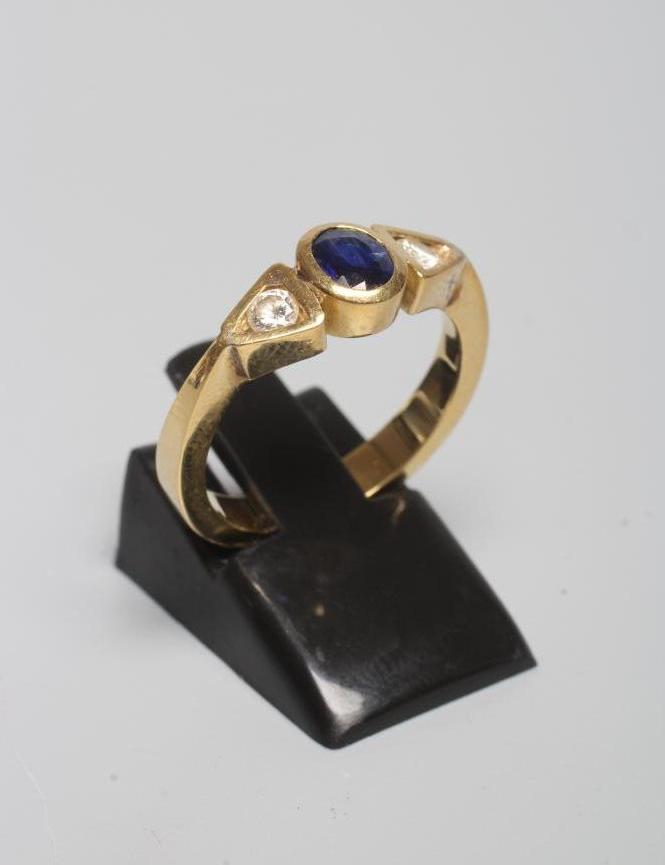 A SAPPHIRE AND DIAMOND THREE STONE RING Image