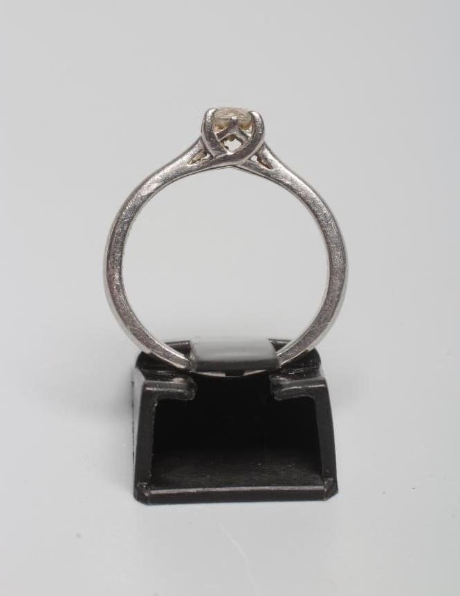 A SOLITAIRE DIAMOND RING, the brilliant cut stone of approximately 0.25cts claw set to a plain Image