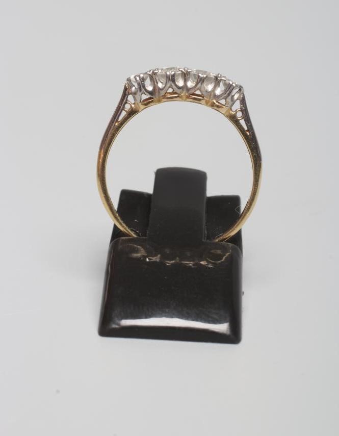A FOUR STONE DIAMOND RING, the graduating old cut stones totalling approximately 0.50cts claw set to Image