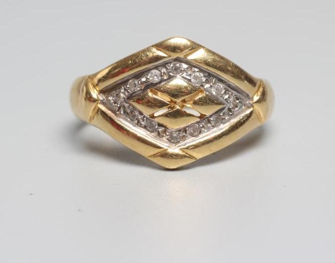A DIAMOND SET SIGNET RING, the lozenge panel pave set with twelve diamond points enclosing a Image