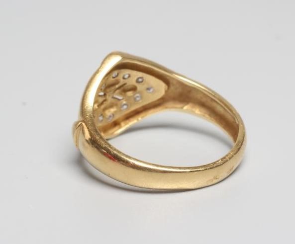 A DIAMOND SET SIGNET RING, the lozenge panel pave set with twelve diamond points enclosing a Image