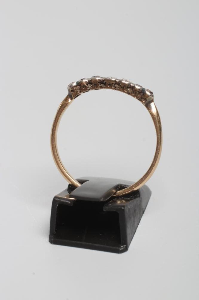 A SEVEN STONE DIAMOND HALF HOOP RING, the graduated mixed cut stones collet set to a plain shank, Image