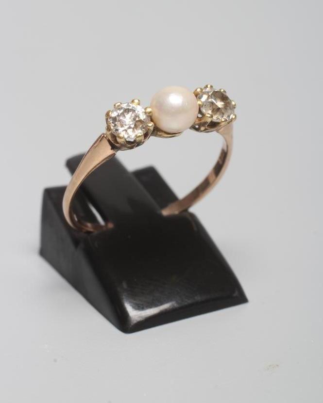 A CULTURED PEARL AND DIAMOND THREE STONE RING Image
