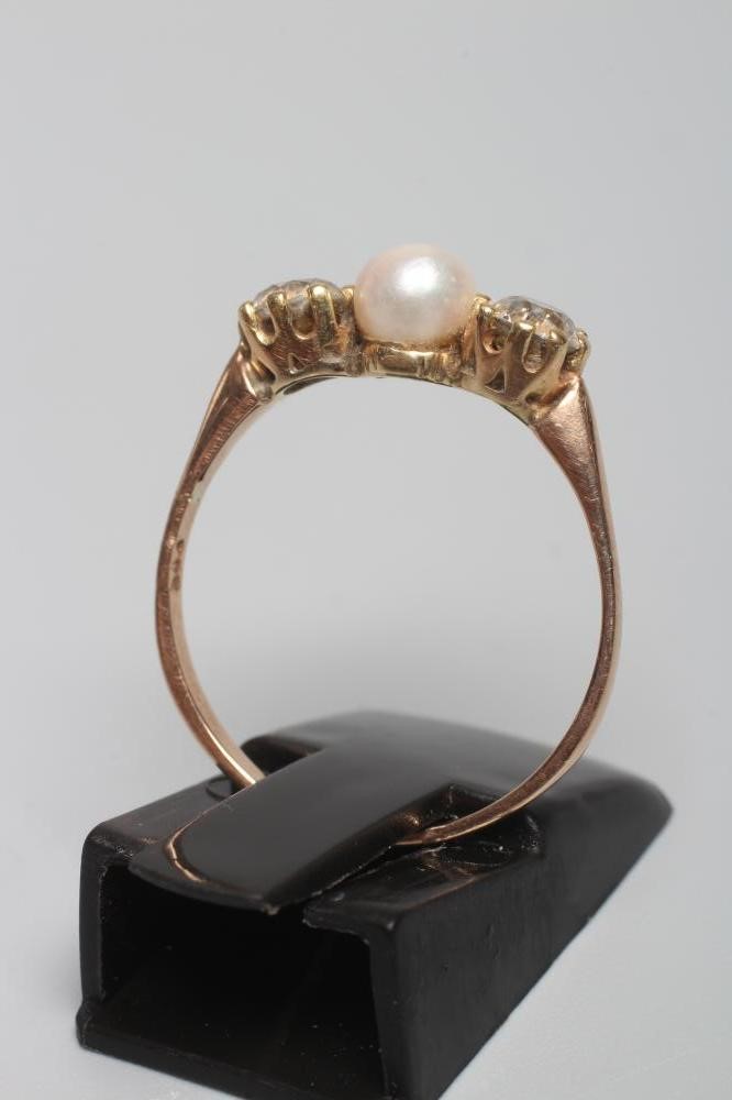 A CULTURED PEARL AND DIAMOND THREE STONE RING Image