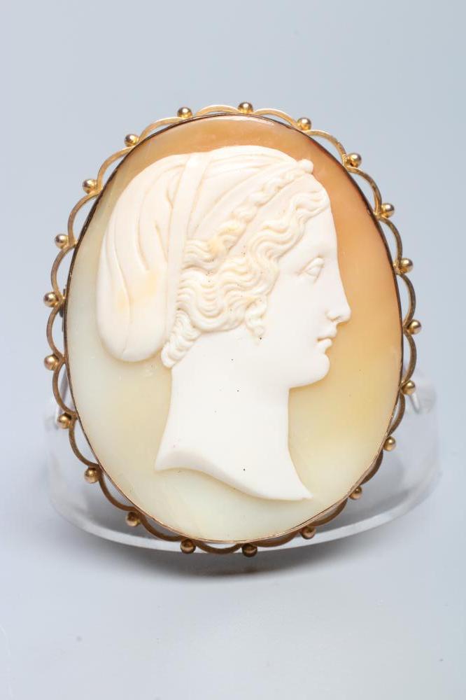 A VICTORIAN SHELL CAMEO carved with the head and shoulders portrait of a young lady wearing a snood Image