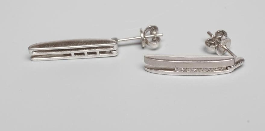 A PAIR OF 18CT WHITE GOLD AND DIAMOND DROP EAR STUDS of elongated oblong form with one matt and one Image