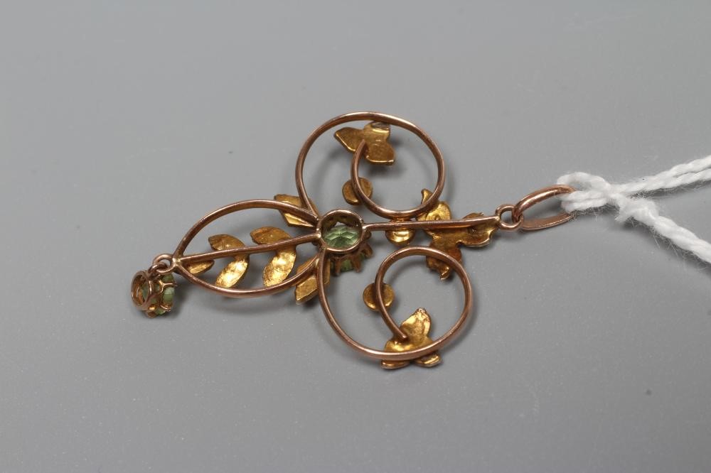 AN EDWARDIAN OPEN WIREWORK TREFOIL PENDANT centred by two facet cut peridots and with seed pearl set Image