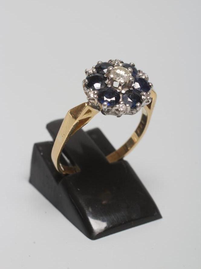 A SAPPHIRE AND DIAMOND CLUSTER RING Image