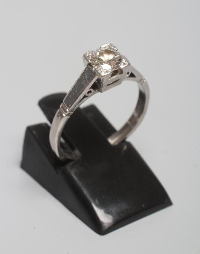A SOLITAIRE DIAMOND RING, the old cut stone of approximately 0.6cts set to a plain white shank Image