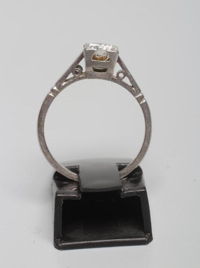 A SOLITAIRE DIAMOND RING, the old cut stone of approximately 0.6cts set to a plain white shank Image