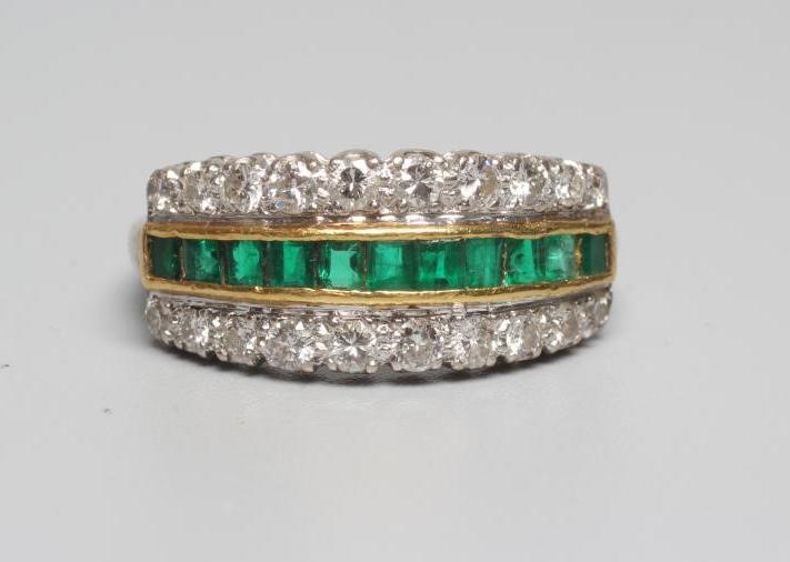 AN EMERALD AND DIAMOND HALF HOOP RING channel set with eleven square cut emeralds within borders Image