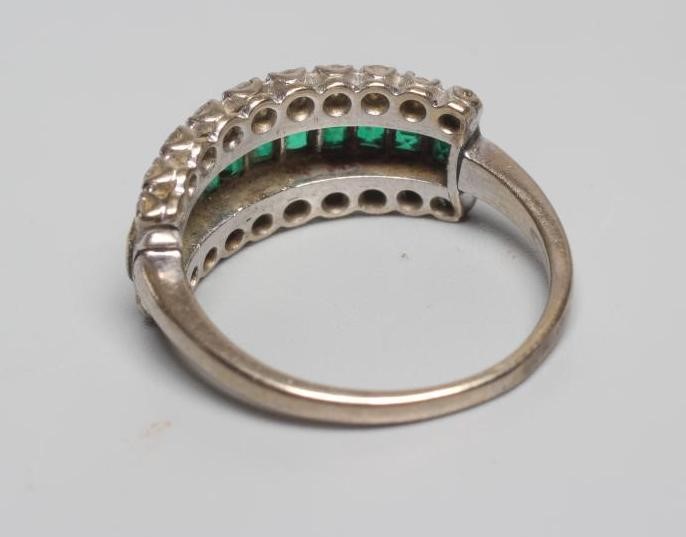 AN EMERALD AND DIAMOND HALF HOOP RING channel set with eleven square cut emeralds within borders Image