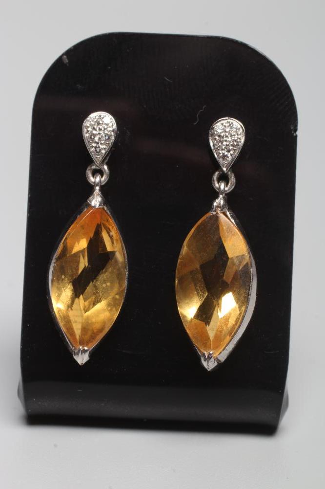 A PAIR OF CITRINE DROP EAR STUDS, the marquise cut stones collet set to a plain white frame and Image