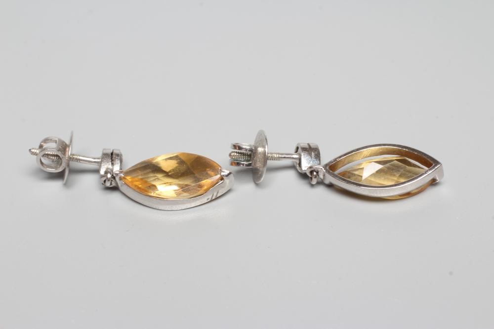 A PAIR OF CITRINE DROP EAR STUDS, the marquise cut stones collet set to a plain white frame and Image