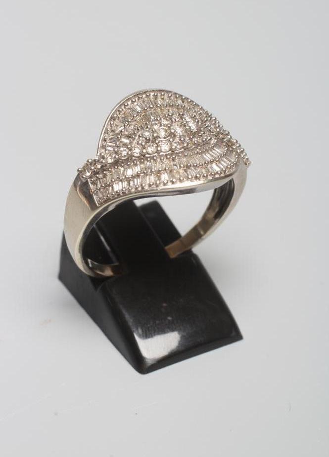 A DIAMOND COCKTAIL RING, the entwined panel point set with numerous small brilliant and baguette cut Image