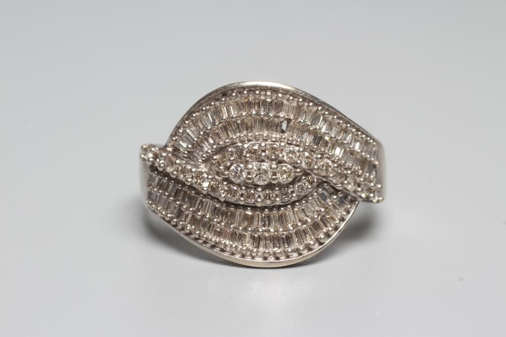 A DIAMOND COCKTAIL RING, the entwined panel point set with numerous small brilliant and baguette cut Image