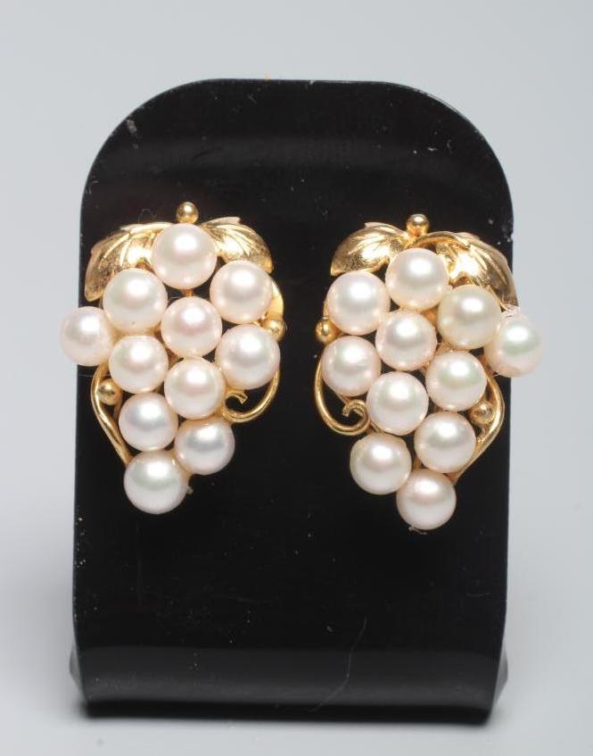 A PAIR OF CULTURED PEARL GRAPE EAR STUDS, the eleven pearls peg set to a scrolling wirework frame Image