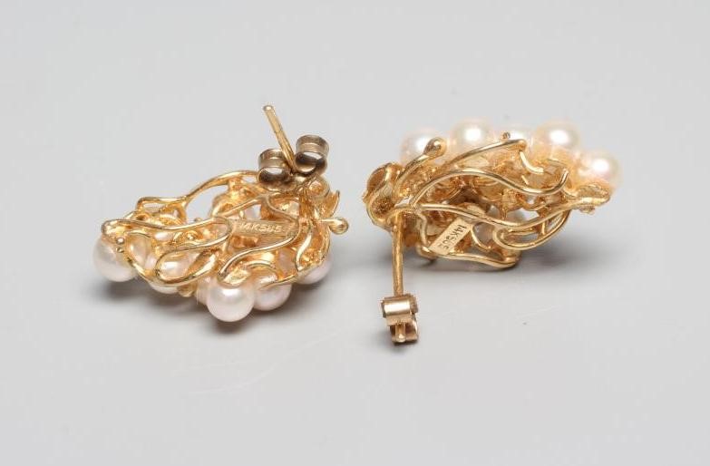 A PAIR OF CULTURED PEARL GRAPE EAR STUDS, the eleven pearls peg set to a scrolling wirework frame Image