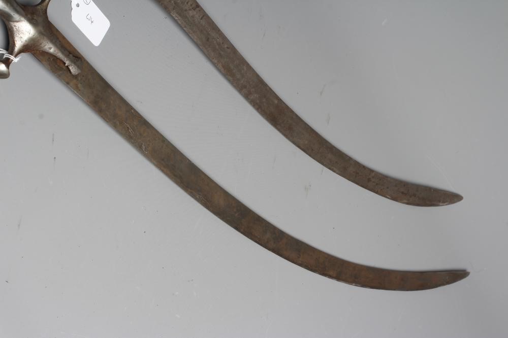 TWO INDIAN TALWAR both with curved blades, extended langets, twin quillon and disc pommels, one with Image
