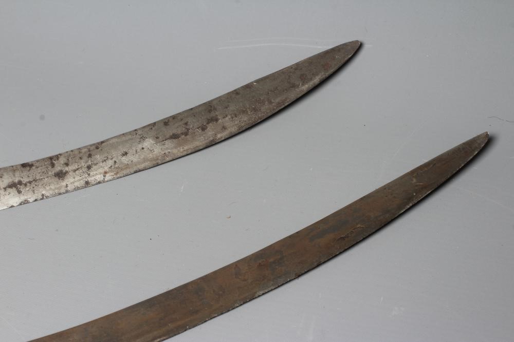TWO INDIAN TALWAR both with curved blades, extended langets, twin quillon and disc pommels, one with Image