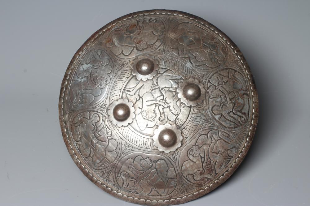 AN INDIAN STEEL CIRCULAR DHAL SHIELD with four bosses and decorated with erotic scenes, 17" diameter Image