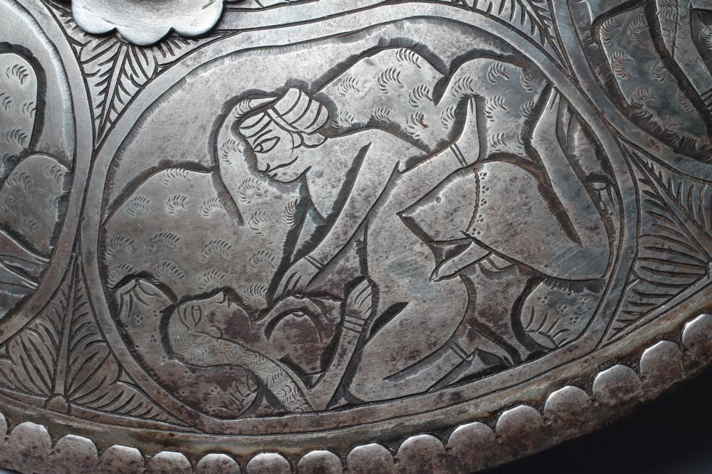 AN INDIAN STEEL CIRCULAR DHAL SHIELD with four bosses and decorated with erotic scenes, 17" diameter Image