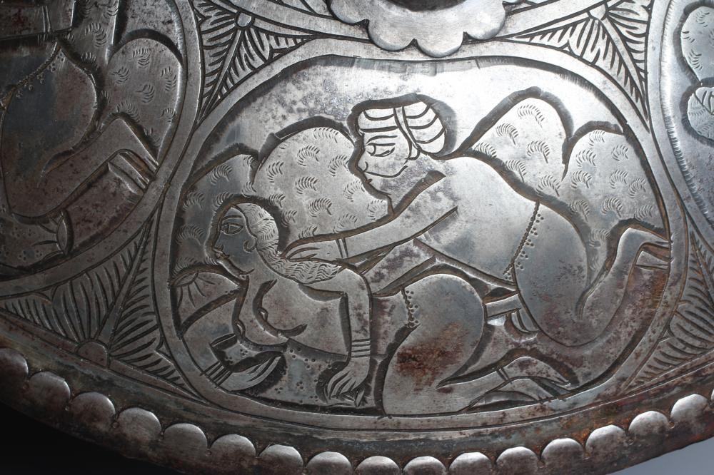 AN INDIAN STEEL CIRCULAR DHAL SHIELD with four bosses and decorated with erotic scenes, 17" diameter Image