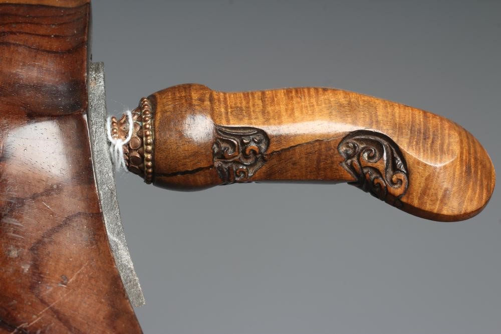 THREE INDONESIAN KRIS DAGGERS with shaped and laminated steel blades, carved grips and typical two Image