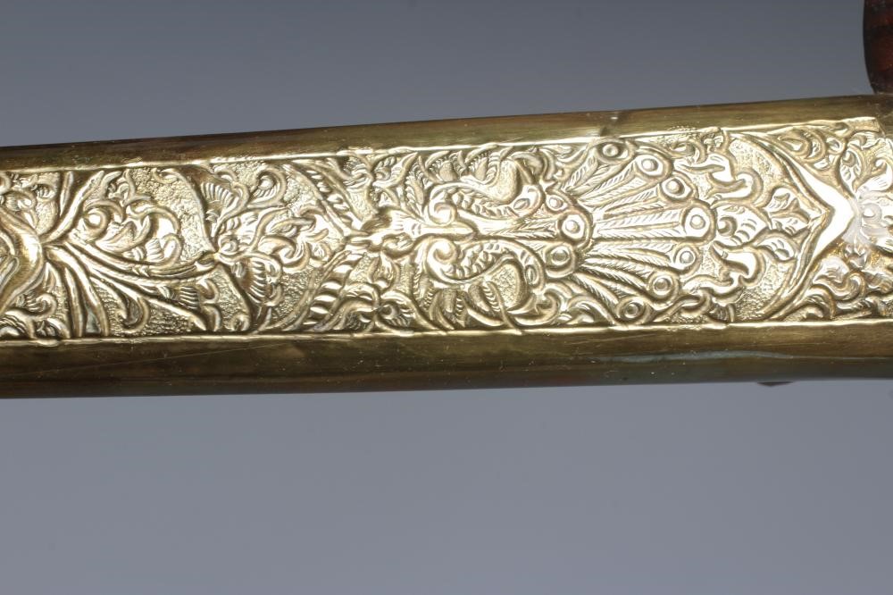 THREE INDONESIAN KRIS DAGGERS with shaped and laminated steel blades, carved grips and typical two Image