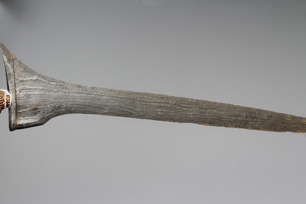 THREE INDONESIAN KRIS DAGGERS with shaped and laminated steel blades, carved grips and typical two Image