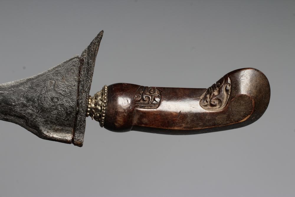 THREE INDONESIAN KRIS DAGGERS with shaped and laminated steel blades, carved grips and typical two Image
