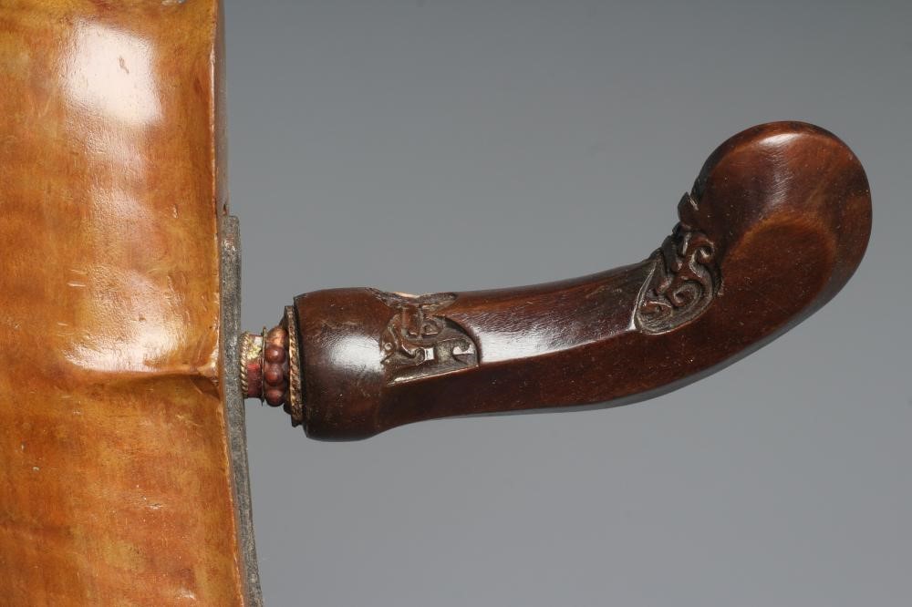 THREE INDONESIAN KRIS DAGGERS with shaped and laminated steel blades, carved grips and typical two Image